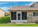 Enclosed sunroom with screened windows and a door to the exterior at 6514 Thicket Trl, New Port Richey, FL 34653