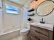 Bathroom featuring a tub/shower combo and modern vanity with updated fixtures at 6534 Fairway Gardens Dr # 17-201, Bradenton, FL 34203