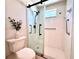 Updated bathroom features a modern glass shower enclosure and accessible grab bars at 6534 Fairway Gardens Dr # 17-201, Bradenton, FL 34203