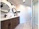 Modern bathroom featuring a double vanity with stylish lighting and a glass-enclosed shower at 6534 Fairway Gardens Dr # 17-201, Bradenton, FL 34203