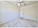 Unfurnished bedroom with neutral carpet, ceiling fan, and a door on the right at 6534 Fairway Gardens Dr # 17-201, Bradenton, FL 34203