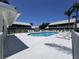 Well-maintained community pool with lounge chairs and shade umbrellas at 6534 Fairway Gardens Dr # 17-201, Bradenton, FL 34203