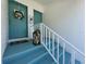 Townhome entrance with blue painted stairs, white railing, wreath and décor at 6534 Fairway Gardens Dr # 17-201, Bradenton, FL 34203