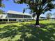 Charming condo building with screened patios, surrounded by lush green lawns and mature trees at 6534 Fairway Gardens Dr # 17-201, Bradenton, FL 34203