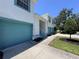 Bright exterior elevation of townhome with turquoise garage door and trim detail at 6534 Fairway Gardens Dr # 17-201, Bradenton, FL 34203
