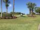 Golf course view with cart and vibrant floral landscaping at 6534 Fairway Gardens Dr # 17-201, Bradenton, FL 34203
