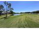 Scenic golf course view featuring a tranquil pond and lush green fairway at 6534 Fairway Gardens Dr # 17-201, Bradenton, FL 34203