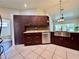 Bright kitchen with stainless appliances, dark cabinets, light countertops and tile floors at 6534 Fairway Gardens Dr # 17-201, Bradenton, FL 34203