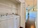 Convenient laundry room with full-size washer and dryer, plus shelving for storage at 6534 Fairway Gardens Dr # 17-201, Bradenton, FL 34203