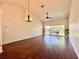 Spacious living room featuring wood floors, tall ceilings, and sliding glass doors to an outdoor patio at 6534 Fairway Gardens Dr # 17-201, Bradenton, FL 34203
