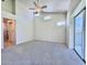 Unfurnished bedroom with neutral carpet, ceiling fan, and a door on the left at 6534 Fairway Gardens Dr # 17-201, Bradenton, FL 34203
