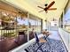 Spacious screened patio offers golf course views and a cozy seating area with ceiling fans at 6534 Fairway Gardens Dr # 17-201, Bradenton, FL 34203