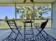 Enjoy serene views from this screened patio with comfortable seating and patterned rug at 6534 Fairway Gardens Dr # 17-201, Bradenton, FL 34203