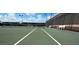 Well-maintained tennis court with white benches and black net at 6534 Fairway Gardens Dr # 17-201, Bradenton, FL 34203