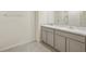 Bathroom vanity area with double sinks, neutral cabinets, and a granite countertop at 7530 Broad Pointe Dr, Zephyrhills, FL 33540