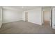Neutral colored bedroom with a window and a door leading to another room at 7530 Broad Pointe Dr, Zephyrhills, FL 33540
