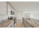 Open-concept kitchen featuring granite countertops and stainless steel appliances leading to living space at 7530 Broad Pointe Dr, Zephyrhills, FL 33540