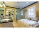 Bright bathroom with a soaking tub, separate glass shower, granite counters and double sinks at 827 S Delaware Ave, Tampa, FL 33606