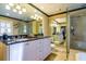 Bathroom showcases double sinks, a frameless glass shower, and plenty of counter space at 827 S Delaware Ave, Tampa, FL 33606