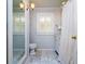 Traditional bathroom featuring marble floors, bright lighting, and a shower and tub combo at 827 S Delaware Ave, Tampa, FL 33606