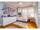 Stylish bedroom with hard wood floors, abundant natural light, and white trim at 827 S Delaware Ave, Tampa, FL 33606