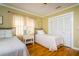 Comfortable bedroom featuring hardwood floors, two twin beds, and ample closet space at 827 S Delaware Ave, Tampa, FL 33606