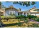 Charming home with beautiful landscaping, a brick walkway, and a welcoming front porch at 827 S Delaware Ave, Tampa, FL 33606