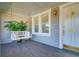 Cozy front porch with a hanging swing bench, complemented by stylish windows and exterior lighting at 827 S Delaware Ave, Tampa, FL 33606