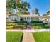 Charming single-story home with manicured lawn, brick walkway, and inviting front porch at 827 S Delaware Ave, Tampa, FL 33606
