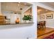 Open kitchen view features granite countertops, white cabinets, stainless appliances, and eat-in dining area at 827 S Delaware Ave, Tampa, FL 33606
