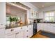 Kitchen featuring white cabinets, granite countertops, stainless steel appliances, and hardwood floors at 827 S Delaware Ave, Tampa, FL 33606