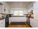 Bright kitchen with white cabinets, stainless steel appliances, and granite countertops at 827 S Delaware Ave, Tampa, FL 33606