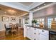Open kitchen view features granite countertops, white cabinets, stainless appliances, and eat-in dining area at 827 S Delaware Ave, Tampa, FL 33606