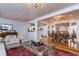 Open-concept living room boasts hardwood floors, a decorative rug, and access to the kitchen and dining area at 827 S Delaware Ave, Tampa, FL 33606