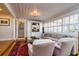 Comfortable living room featuring hardwood floors, custom built-ins, and large windows with plantation shutters at 827 S Delaware Ave, Tampa, FL 33606