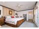 Spacious main bedroom with neutral carpeting, ceiling fan, decorative trim, and ample natural light at 827 S Delaware Ave, Tampa, FL 33606
