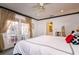 Tranquil bedroom with French doors to the outside, ceiling fan, and ensuite bathroom access at 827 S Delaware Ave, Tampa, FL 33606