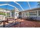Outdoor brick patio and screen enclosure offers an outdoor space perfect for relaxing and entertaining at 827 S Delaware Ave, Tampa, FL 33606