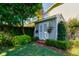 Backyard storage shed featuring climbing plants and brick steps at 827 S Delaware Ave, Tampa, FL 33606