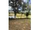 View of the backyard with a picturesque pond beyond the fenced in area at 8361 Cofield Ln, Spring Hill, FL 34608