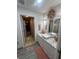 Modern bathroom featuring marble countertop, ample storage, and decorative accents, creating a spa-like retreat at 8361 Cofield Ln, Spring Hill, FL 34608