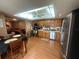 Eat-in kitchen featuring stainless steel appliances, wood cabinets and adjacent dining area at 8361 Cofield Ln, Spring Hill, FL 34608