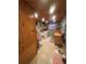 Functional laundry room with wood paneling and modern appliances at 8361 Cofield Ln, Spring Hill, FL 34608
