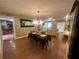 Open-concept living and dining area with hardwood floors and elegant seating, perfect for entertaining guests at 8361 Cofield Ln, Spring Hill, FL 34608