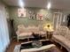 Cozy living room boasts hardwood floors, floral decorations, and comfortable ornate sofas at 8361 Cofield Ln, Spring Hill, FL 34608