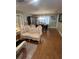 Elegant living room featuring hardwood floors, ornate furniture, and a view into the dining area at 8361 Cofield Ln, Spring Hill, FL 34608