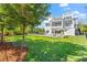 Expansive backyard with lush lawn, mature trees, and inviting pool area at 885 Seaview Cir # 20, Crystal Beach, FL 34681