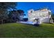A three-story white home boasts an inviting pool and lush lawn, ideal for outdoor activities and relaxation at 885 Seaview Cir # 20, Crystal Beach, FL 34681
