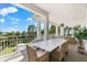 Spacious outdoor balcony with dining and lounge areas, perfect for entertaining with stunning nature views at 885 Seaview Cir # 20, Crystal Beach, FL 34681