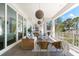 Inviting covered balcony with stylish furniture, ideal for enjoying the peaceful surroundings and waterfront vistas at 885 Seaview Cir # 20, Crystal Beach, FL 34681